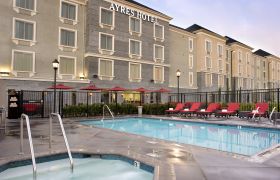 Back exterior and pool area of Ayres Hotel Fountain Valley