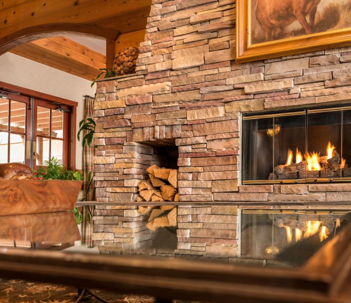 A Fire Place Sitting In A Living Room With A Stone Fireplace