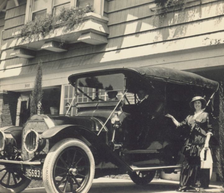 Ayres Family member standing next to a car of the time