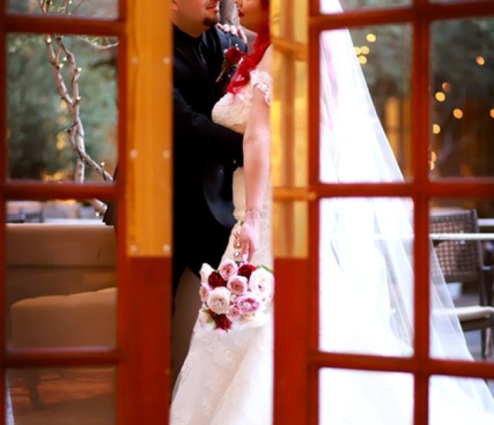 Glimpse of Bride and Groom Through a Glass Door