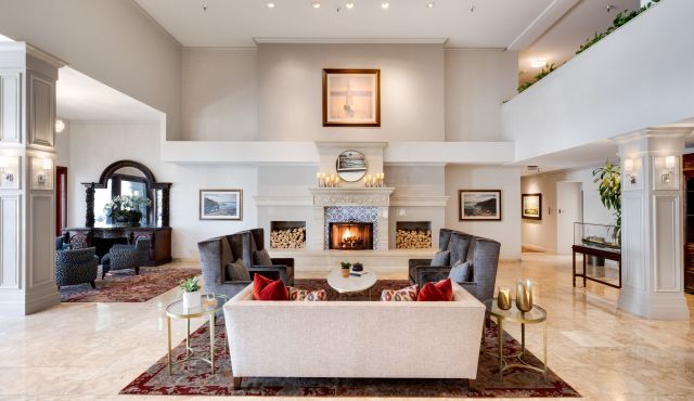 A Living Room Filled With Furniture And A Fire Place