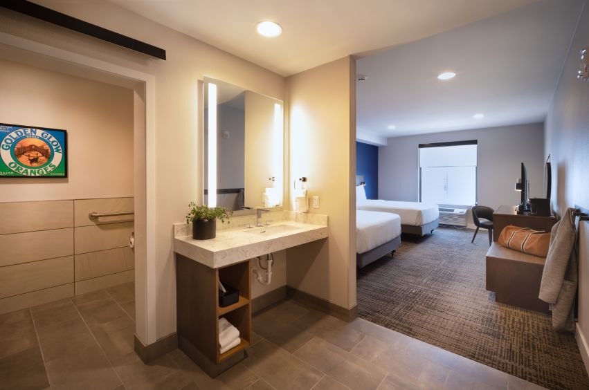 A Bathroom With A Bed And A Sink