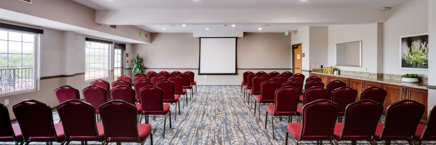 A Room With A Large Group Of Chairs And A Whiteboard